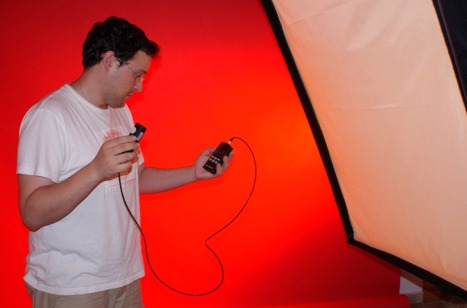 En la imagen superior se puede observar de como el técnico comprueba la iluminación con el medidor de luminancia para la preparación de una sesión de fotografía en un estudio fotográfico.